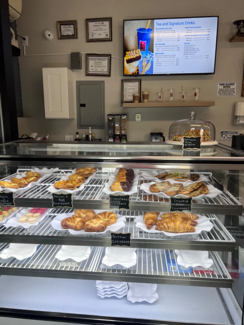Pastry case with croissants and baked goods